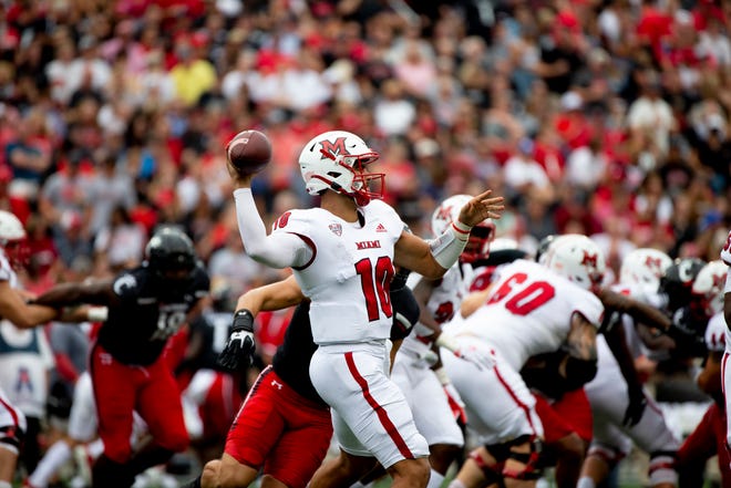 Miami Redhawks quarterback AJ Mayer (10) throws a pass in the first half of the NCAA football game between the Cincinnati Bearcats and the Miami Redhawks on Saturday, Sept. 4, 2021, at Nippert Stadium in Cincinnati.