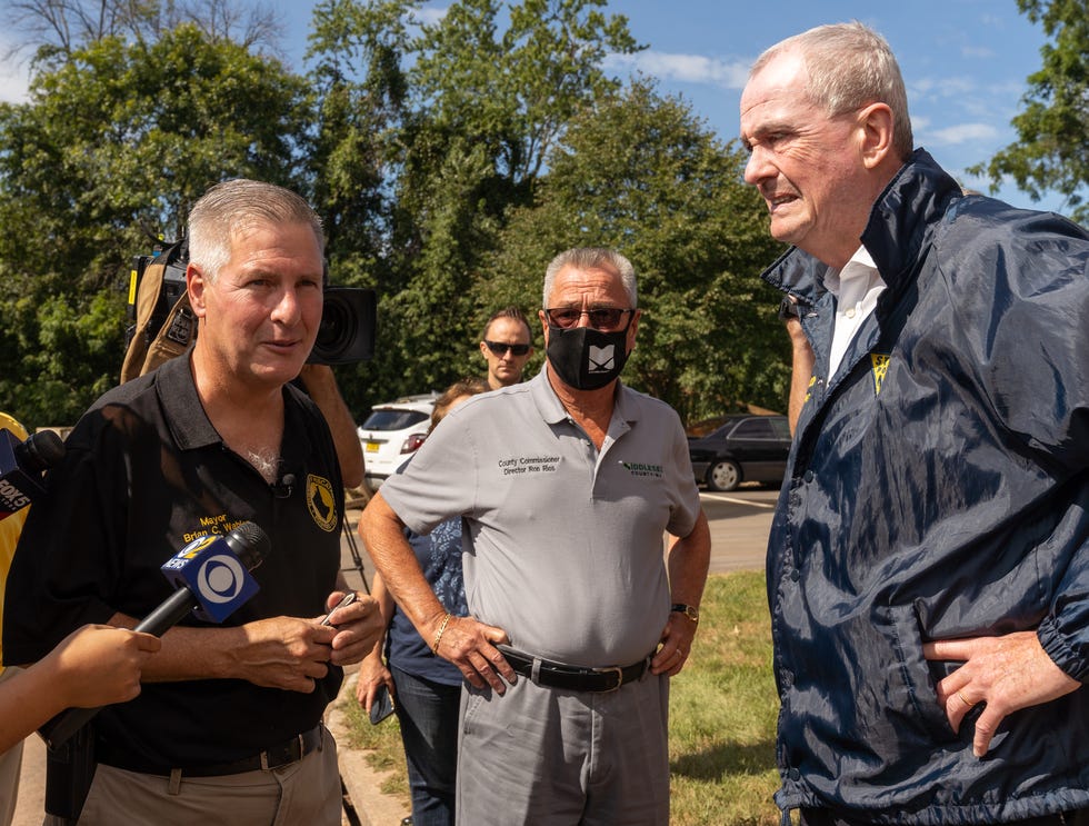 Piscataway Mayor Brian C. Wahler, left, talks to Gov. Phil Murphy, right, during Murphy's visit to the Birchview Garden Apartments on River Road in Piscataway after Hurricane Ida flooding.