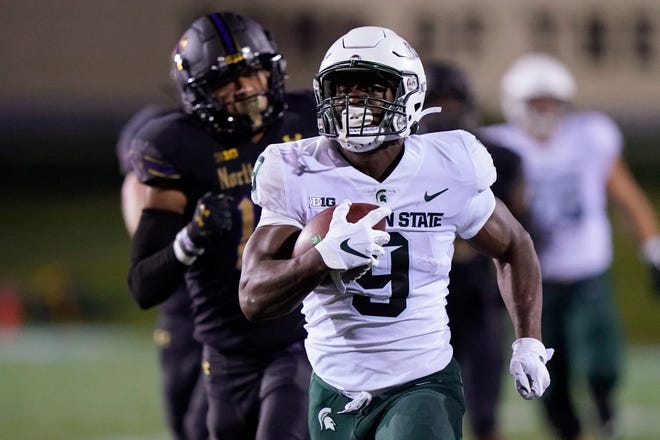 Michigan State running back Kenneth Walker III runs for a touchdown past Northwestern safety Brandon Joseph during the first half on Friday, Sept. 3, 2021, in Evanston, Illinois.