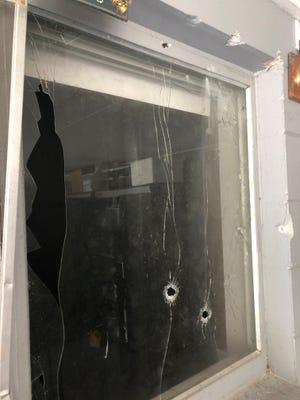 Images of bullet holes in a residence where Polk sheriff's deputies and other police units exchanged fire with a shooting suspect in a neighborhood off North Socrum Loop Road in Lakeland early Sunday.