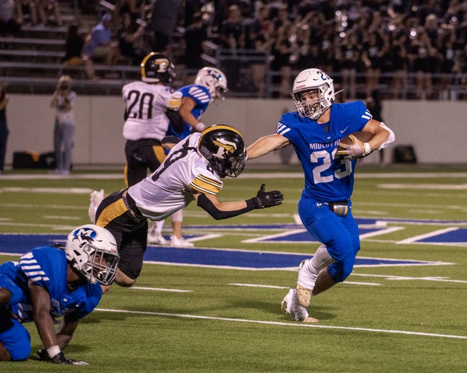 Midlothian senior running back Kaden Smith (23) stiff-arms a would-be Forney tackler during Friday night's game at MISD Multipurpose Stadium. The Panthers defeated the Jackrabbits, 42-13.
