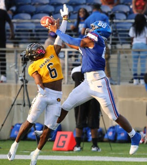 Tennessee's Joshua Truhart can't hold the ball while being defended by Horchie Williams, 6, from Grambling during the 2021 Black College Football Hall of Fame Classic at Tom Benson Hall of Fame in Canton.  Penalty nullifies play.
