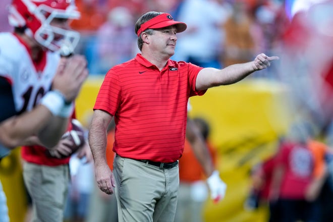 Georgia coach Kirby Smart works with his team before the start of their game against Clemson at Bank of America Stadium in Charlotte, North Carolina.