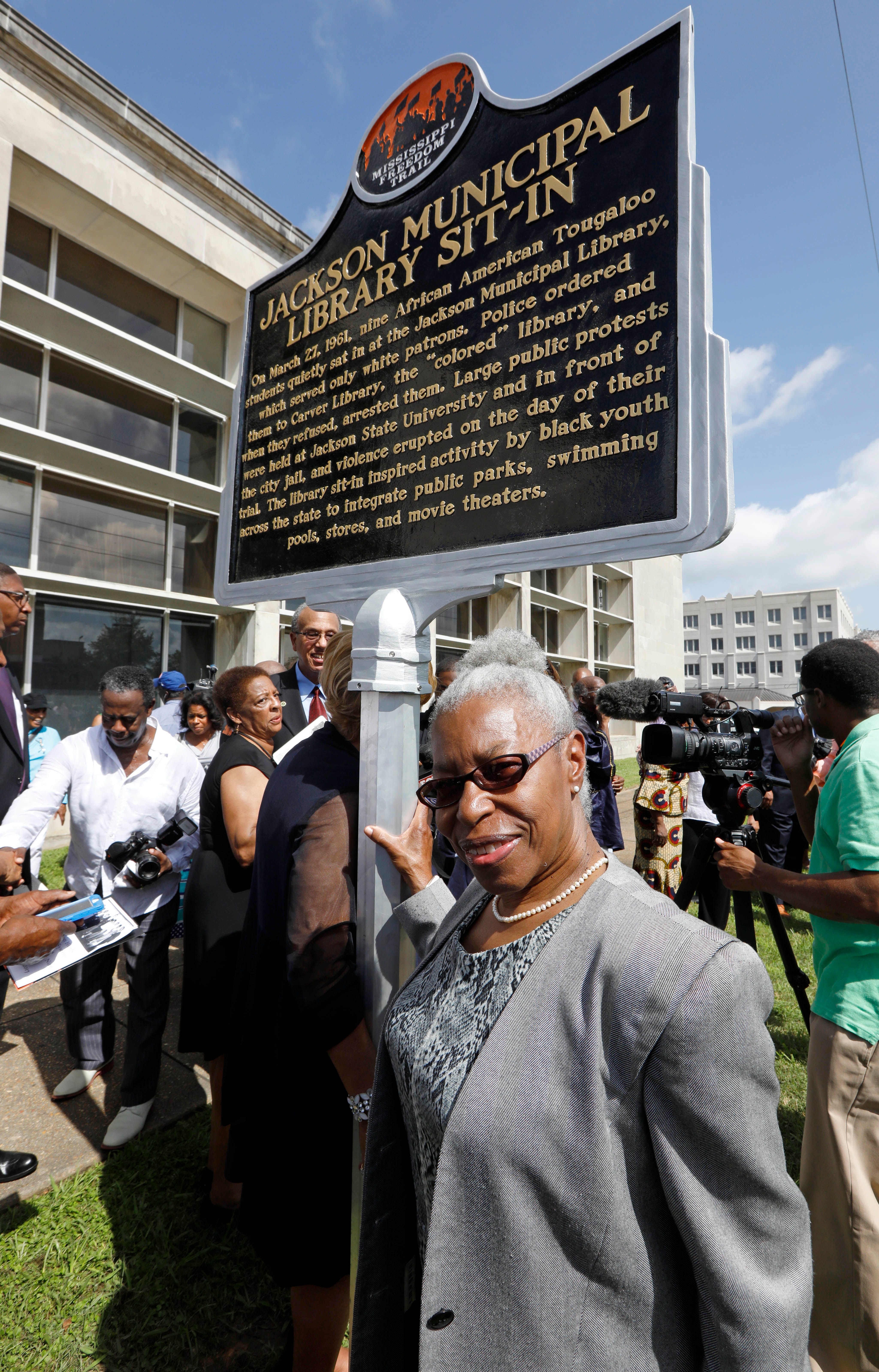 Geraldine Edwards Hollis, a member of the u0022Tougaloo Nine,u0022 stands alongside the newest Mississippi Freedom Trail marker recognizing she and other Tougaloo College students for their peaceful sit-in in 1961 at the then whites-only Jackson Municipal Library, Thursday, Aug. 17, 2017. The library, sitting in the background, has served other purposes since the 1961 sit-in.