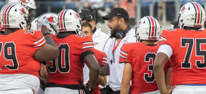 McKinley’s head coach Antonio Hall talks with his players during the season opener against Mentor on Friday, August 20, 2021.