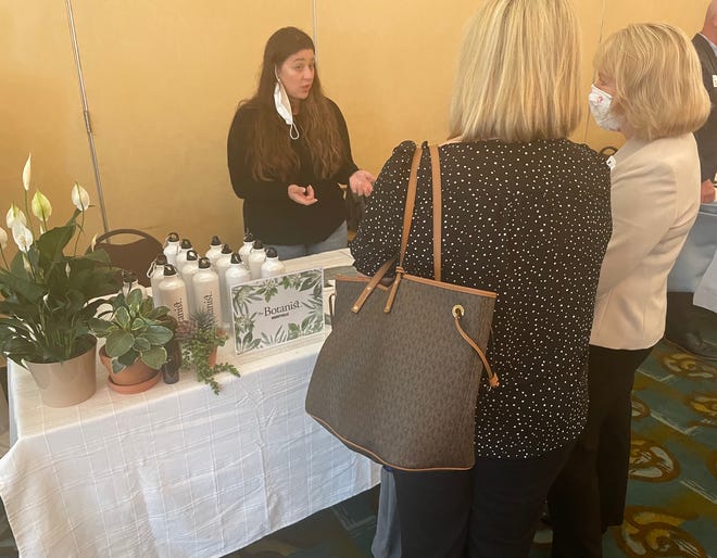 Sierra Lloyd, a patient care coordinator for The Botanist in Uncasville, explains the company to guests at the Chamber of Commerce of Eastern Connecticut's "The Business of Cannabis" Mini Expo Wednesday.