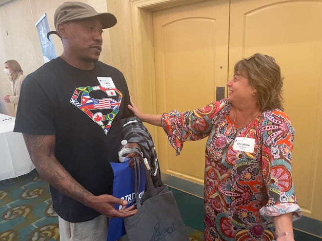 Niantic resident Larry Jackson and Groton Curaleaf pharmacy tech Christine Pacheco talk at the Chamber of Commerce of Eastern Connecticut's "The Business of Cannabis" Mini Expo Wednesday.