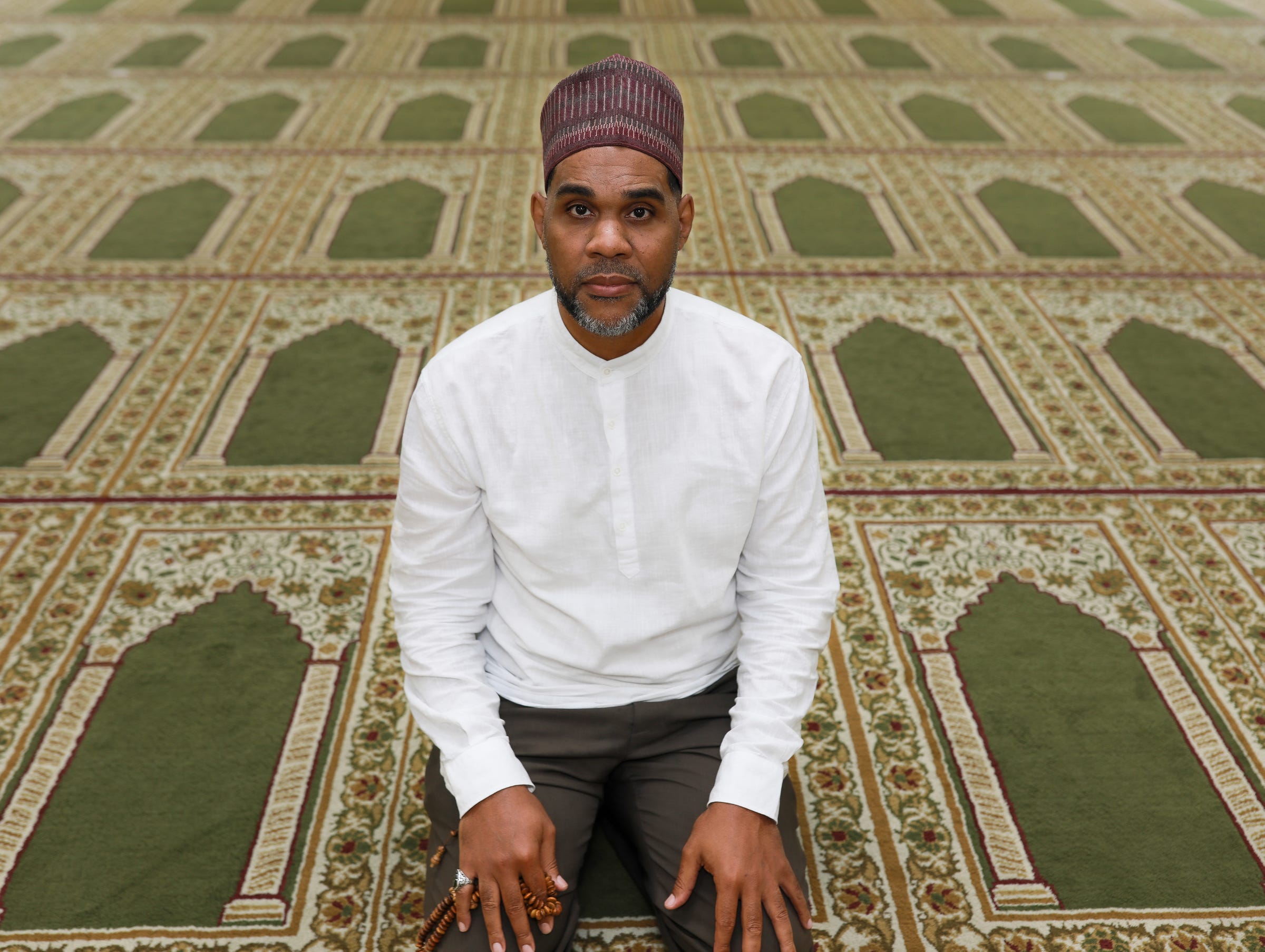 Dawud Walid gives the sermon at the Muslim Center Mosque and Community Center in Detroit on Aug. 27, 2021. Walid is the executive director of the Michigan chapter of the Council on American-Islamic Relations and a member of the Michigan Muslim Community Council Imams Committee. Walid moved to Detroit from Virginia in 1998 after serving four years in the Navy. "At the time in my generation being Muslim was seen as an authentic expression of Blackness," said Walid, and before 9/11 terrorist attacks he remembers going to festivals at Hart Plaza in downtown Detroit and Wayne State University to hand out pamphlets about Islam. When 9/11 happened, Walid was celebrating the birth of his son and his mother, who was visiting from Virginia, had to drive home because all flights had been grounded for weeks. "And shortly after 9/11, I had my tires flattened and my windshield was knocked out."