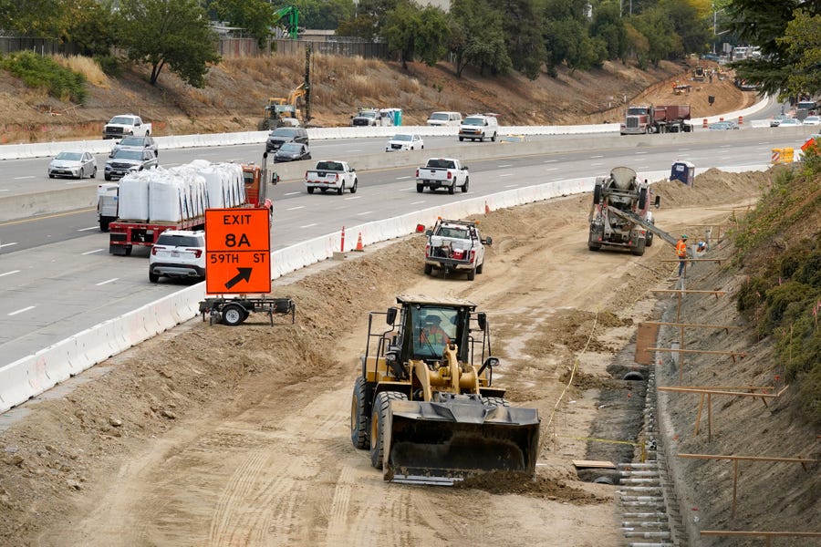 Traffic flows past construction work on eastbound Highway 50 in Sacramento, Calif., on Aug. 12, 2021. The work is part the California Department of Transportations comprehensive project that would improve Highway 50 with the construction of High Occupancy Vehicle lanes.