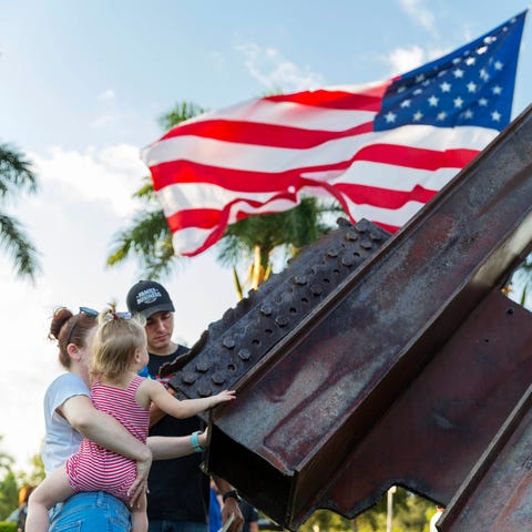 Logan, Molly and Presley Kruse, 1, touch steel bea