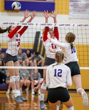 Glen Rose's Ava Sehnert (3) and Matti Young (11) put up a block against Godley hitter on Tuesday night in Godley.