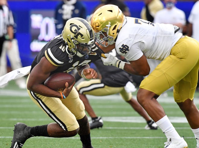 Isaiah Foskey, right, has a knack for chasing down quarterbacks, like Georgia Tech's Jeff Sims last season. But Notre Dame's starting vyper has added more linebacker duties to his defensive end role.