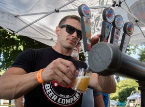 Charlie Lippert with the Lodi-based- Five Windows Beer Company pours a beer at the annual Stockton Brew Fest held at the Waterloo Gun and Bocce Club in east Stockton.