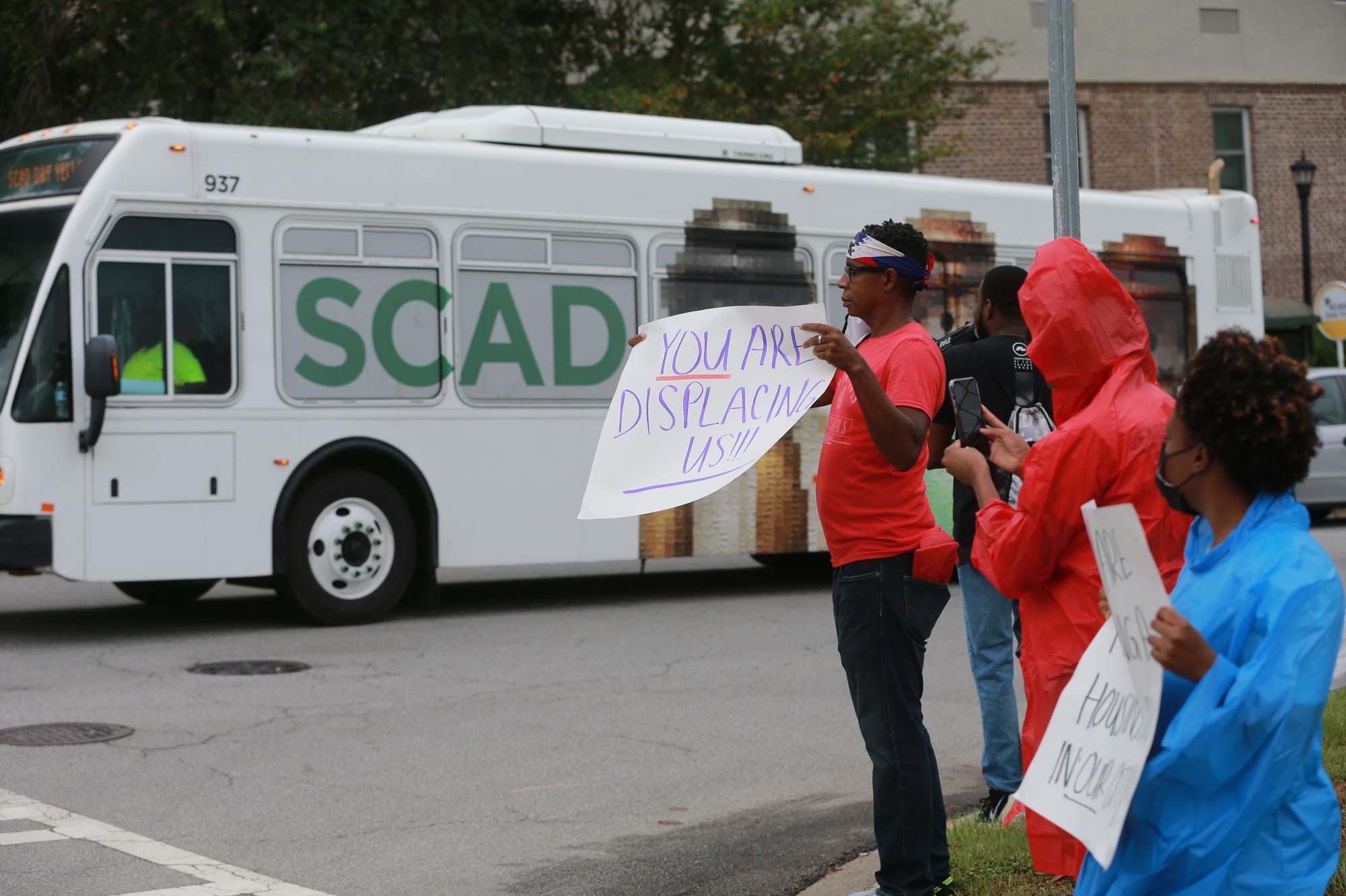 The 912 Liberation Crew protests across from the Savannah College of Art and Design's Turner Hall, a first-year residential facility built in 2008 on land that was once a rail yard. The 912 Liberation Crew, led by Savannah-native Keiajah Brooks, says SCAD's expanding footprint is responsible for displaying Black families.