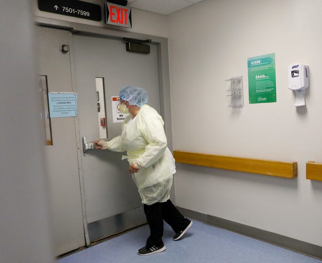 Registered nurse Rocio Rosario walks into Covid-19 unit 75 after putting on her PPE at UF Health after talking with The Gainesville Sun about her experiences working at the hospital through the Covid-19 pandemic, in Gainesville, Fla. Sept. 8, 2021.