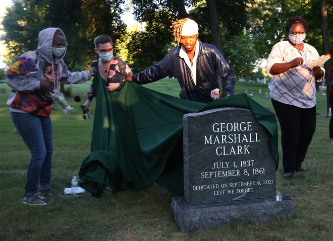 Tyrone Randle, (second from right) who lead the efforts to raise funds for the unmarked grave of George Marshall Clark, is helped with the unveiling with Kamila Ahmed, left and Aadya (cq) Wyhtner Forest Home Cemetery in Milwaukee. Clark is the only recorded lynching in Milwaukee that took place on Sept. 8, 1861 at the corner of Water and Buffalo streets in Milwaukee.