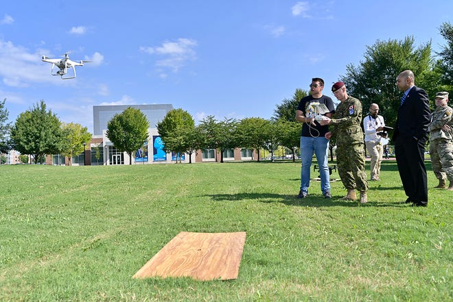 MTSU aerospace unmanned aircraft systems senior Corwin Cordell of Chattanooga, Tenn., offers U.S. Army Brig. Gen. Bob Ritchie pointers in flying a drone as Chaminda Prelis, first year Aerospace Department chair, watches. Officials with the Army's 101st and XVIII Airborne Divisions signed and educational partnership agreement Wednesday, Sept. 8, to promote collaboration in the STEM fields and innovation.