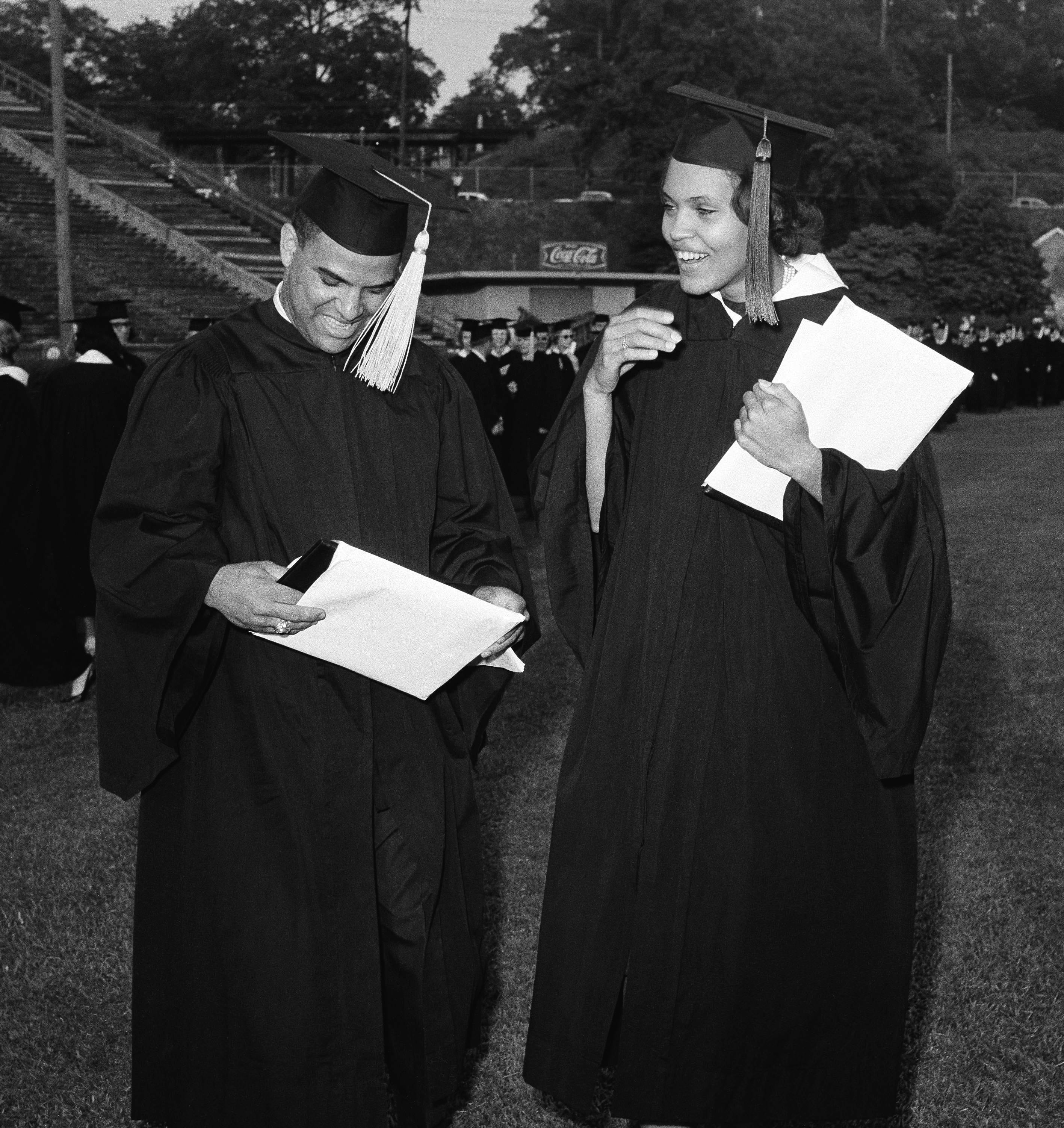 Hamilton Holmes and Charlayne Hunter of Atlanta examine diplomas awarded during the University of Georgia's 160th commencement in Athens, Georgia, June 3, 1963. They were the first Black students to attend the nation's oldest land grant college.