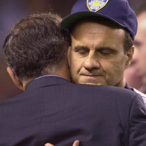 Joe Torre hugs then-New York mayor Rudy Giuliani.