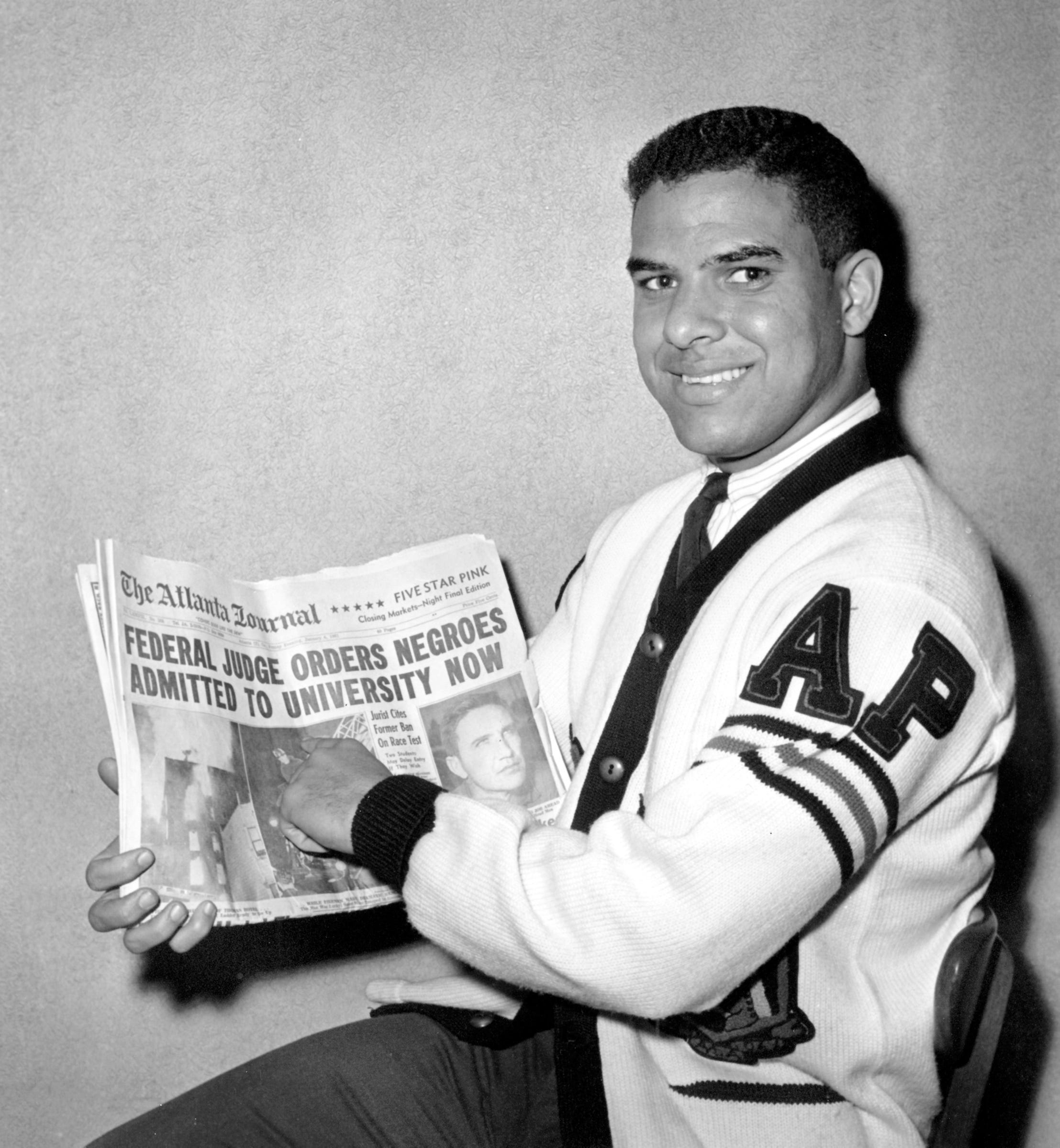 Hamilton E. Holmes, 19, displays The Atlanta Journal's headlines on Jan. 6, 1961, after he and Charlayne Hunter, 18, were ordered admitted immediately to the University of Georgia, an all-white college. U.S. District Judge W.A. Bootle ruled that they had been denied admission because of race. Holmes was a pre-med student at Morehouse College in Atlanta. Hunter was studying journalism at Wayne State University in Detroit.