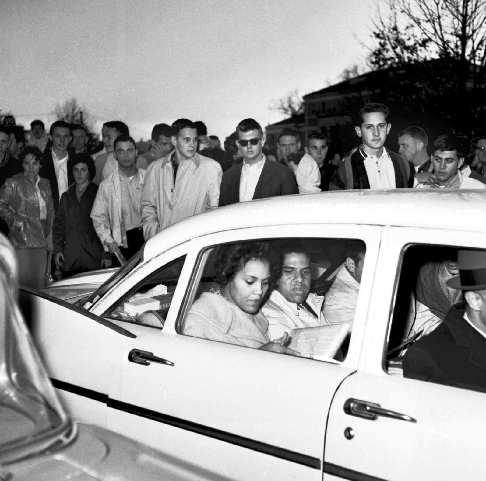 University of Georgia students shout and jeer in this 1961 photo at Charlayne Hunter, 18, left, and Hamilton Holmes, 19, as they leave the administration building after completing registration at Athens, Ga.