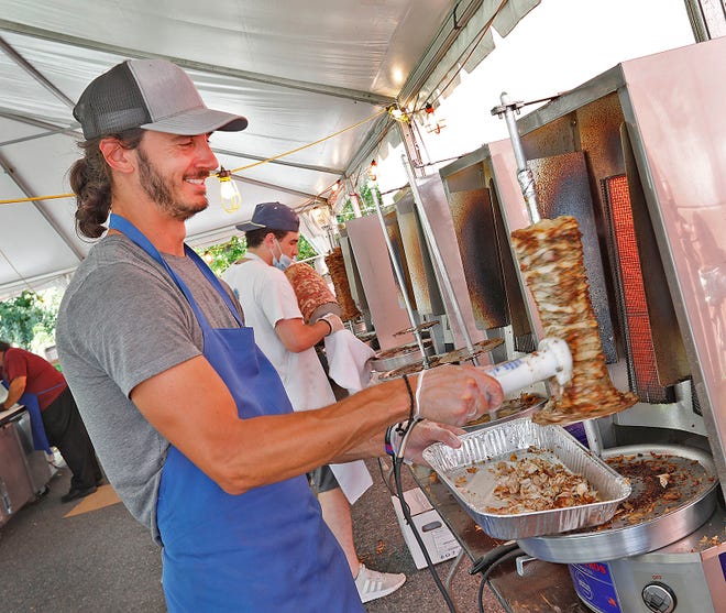 Cook Andrew Purner of Milton shaves some cooked chicken for gyros during the St. Catherine Greek Orthodox Gyro Festival on Friday, Sept. 10, 2021.