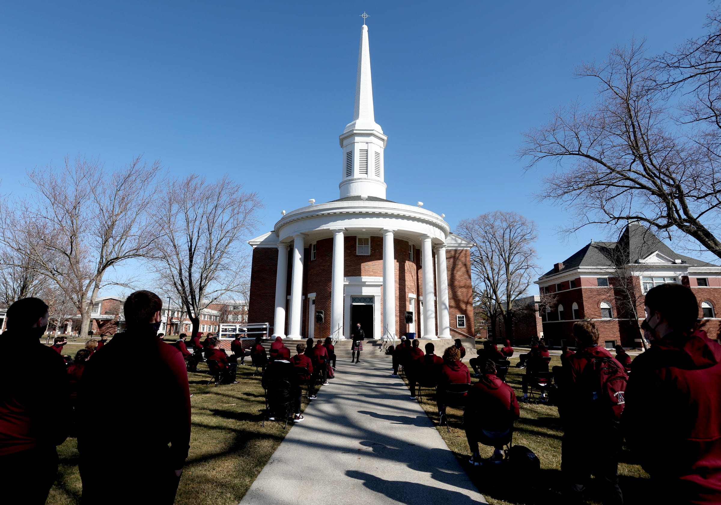 Andrew Pommerville, the Alma College chaplain, gives a chapel service to the Alma football team before their game against Adrian College in Alma, Michigan on Saturday, March 20, 2021.
