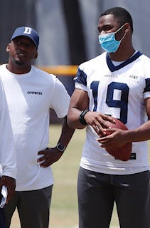 Shawn Lewis (left), a graduate of San Angelo Lake View High School, stands next to Dallas Cowboys wide receiver during a coaching internship with the team during training camp this summer.