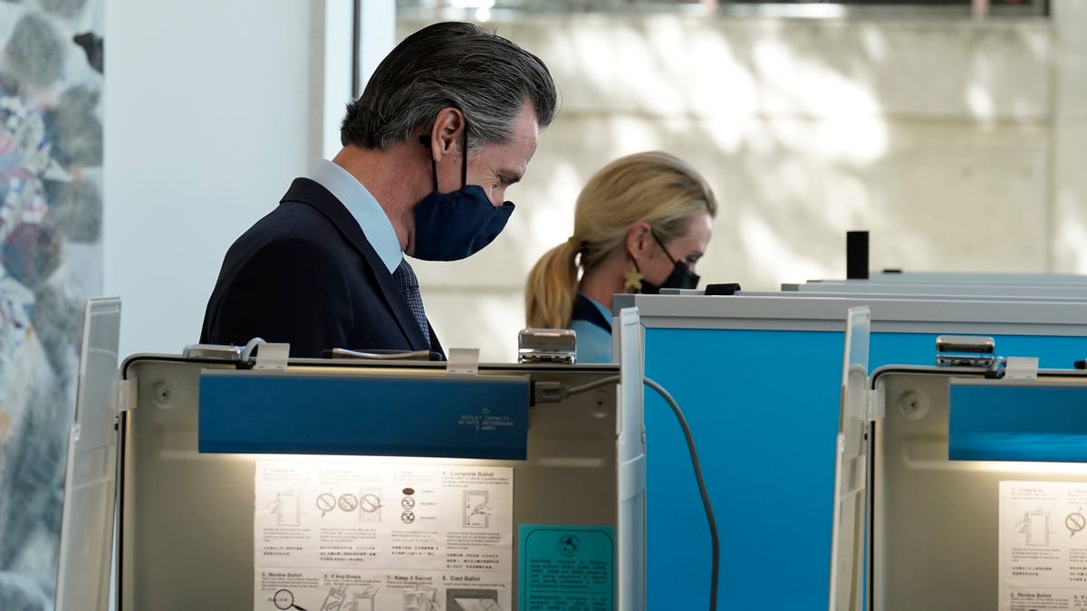 California Gov. Gavin Newsom, and his wife First Partner Jennifer Siebel Newsom mark their ballots at a voting center in Sacramento, Calif., Friday, Sept. 10, 2021.