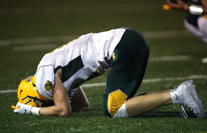 Blackhawk's Carson Heckathorn falls to the ground after Blackhawk misses a field goal in the final seconds of the game and falls to North Catholic 17-18 Friday night at J.C. Stone Field in North Park.