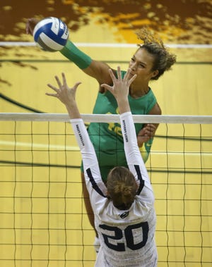 Oregon's Karson Bacon, top, goes for a kill against Penn State at Matthew Knight Arena earlier this season.
