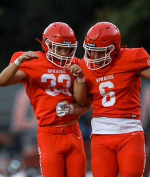 Sprague's Barik Hill (33) celebrates with Sprague's Cole Elmore (6) after a touchdown during the game against  Century on Friday, Sept. 10, 2021 at Sprague High School in Salem, Ore. 