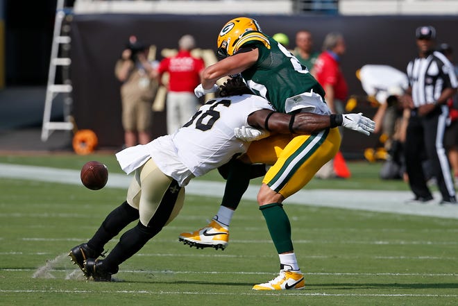 New Orleans Saints outside linebacker Demario Davis, left, breaks up a pass intended for Green Bay Packers tight end Robert Tonyan during the first half of an NFL football game, Sunday, Sept. 12, 2021, in Jacksonville, Fla.