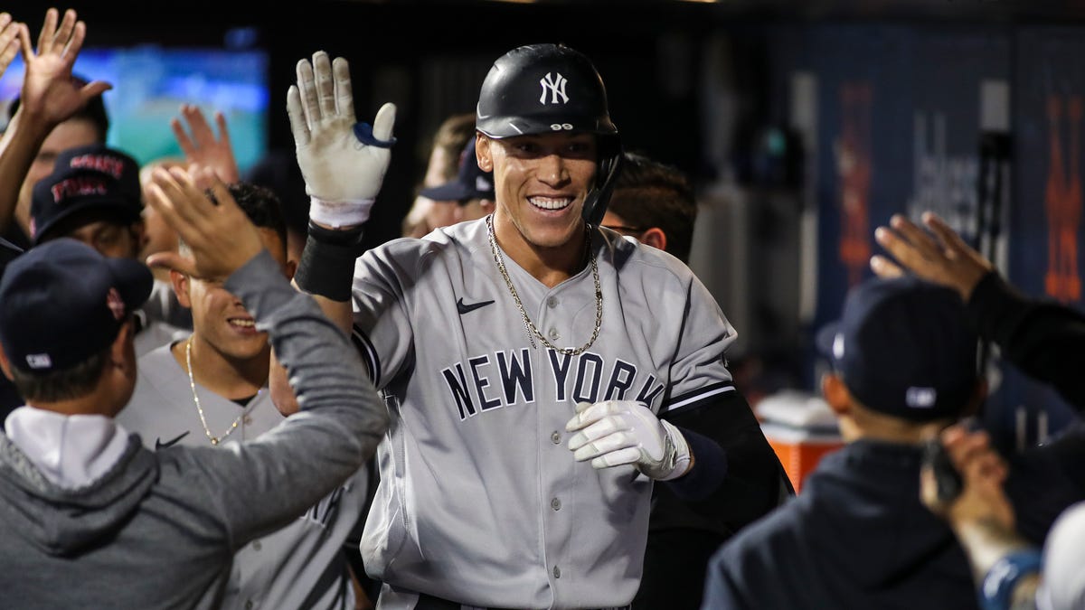 New York Yankees right fielder Aaron Judge is greeted in the dugout after hitting a solo home run in the second inning against the New York Mets at Citi Field.