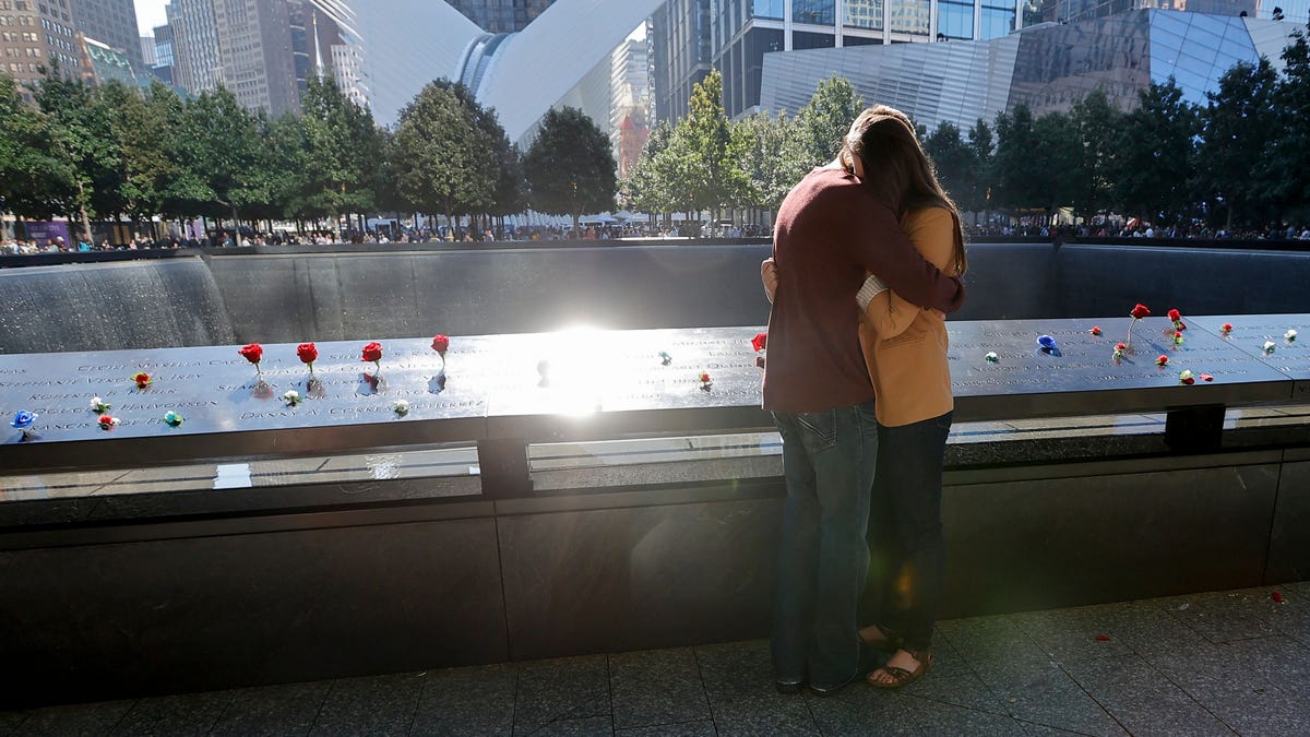 People mourn at the 9/11 Memorial on the 20th anniversary of the September 11 attacks in Manhattan, New York on September 11, 2021.