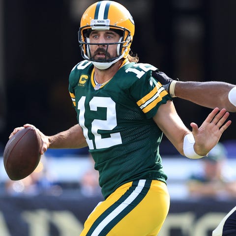 Aaron Rodgers #12 of the Green Bay Packers looks t