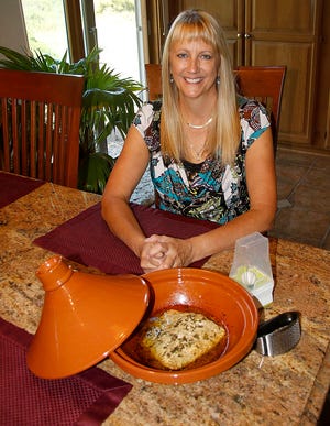 Kristy Schemich with her salmon made in a tangini and a couple other cooking gadgets on the table. TOM E. PUSKAR/TIMES-GAZETTE.COM