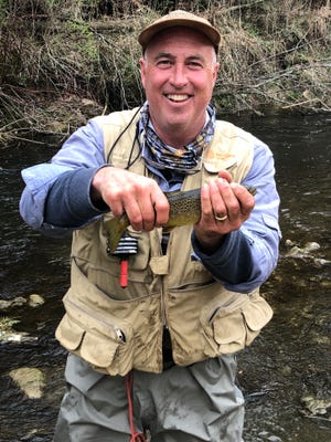 John Chalstrom holds a trout caught while fly-fishing in the Driftless Area in northeast Iowa.