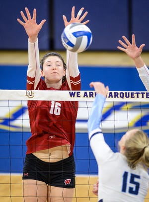 Wisconsin middle blocker Dana Rettke (16) blocks Marquette outside hitter Ellie Koontz (15) in a women's college volleyball match Sunday, September 12, 2021, at the Al McGuire Center in Milwaukee, Wisconsin.