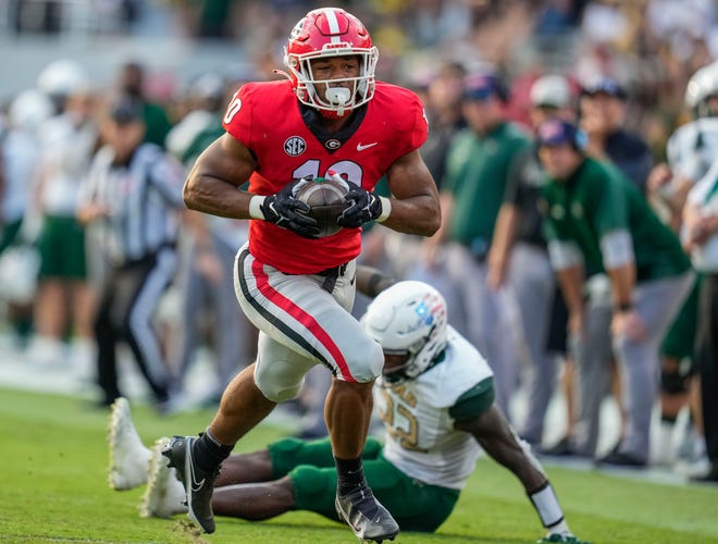 Georgia linebacker Jamon Dumas-Johnson ( 10 ) intercepts a pass that he returns for a touchdown against Alabama-Birmingham during the second half at Sanford Stadium.