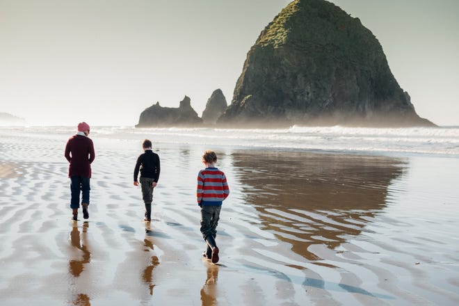 Cannon Beach, Oregon, is known for its sea stack rock formations, the most famous of which is Haystack Rock, a nesting area for puffins.