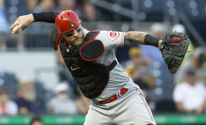 Sep 14, 2021; Pittsburgh, Pennsylvania, USA; Cincinnati Reds catcher Tucker Barnhart (16) throws to first base to retire Pittsburgh Pirates second baseman Wilmer Difo (not pictured) to end the first inning at PNC Park. Mandatory Credit: Charles LeClaire-USA TODAY Sports