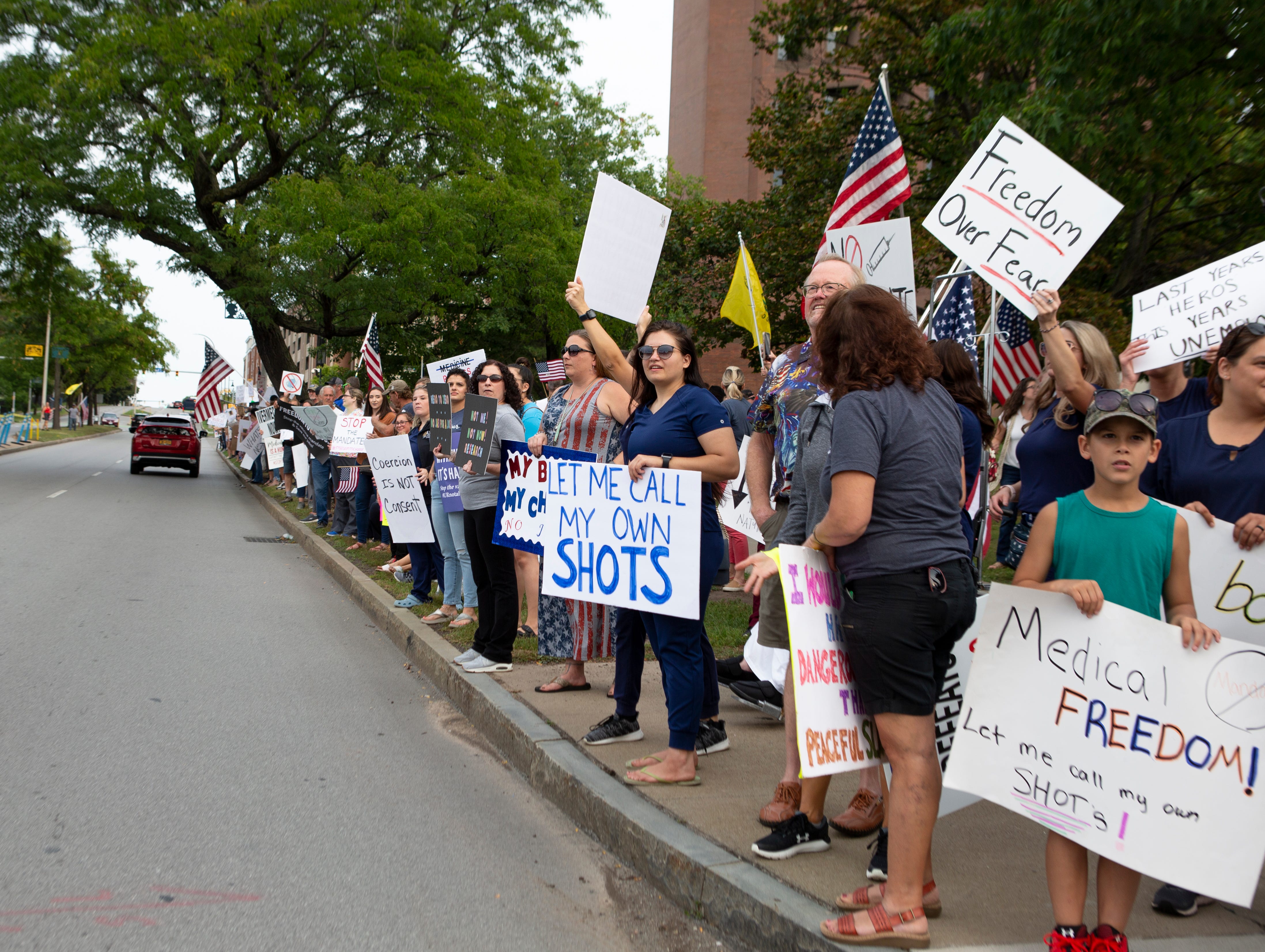 Protesters wave their signs to ongoing traffic during a Medical Freedom Rally outside the University of Rochester Medical Center in Rochester, New York, on Sept. 13, 2021. There were about 500 people in attendance.