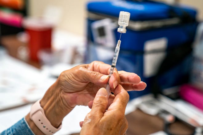 A vaccine provider prepares a dose of the COVID-19 vaccine at a clinic run by the Allegheny County Health Department at Casa San Jose, a non-profit organization serving Latino immigrants in the Beechview neighborhood of Pittsburgh, Pennsylvania.