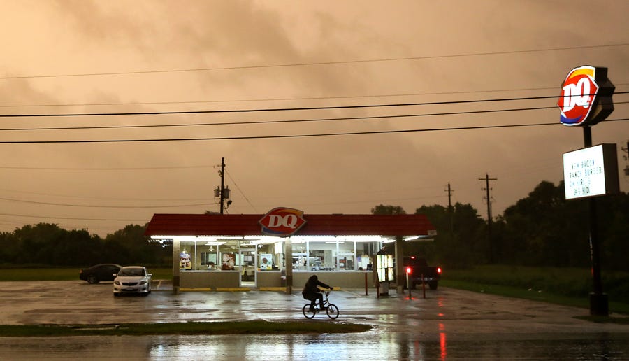 A Dairy Queen in Bay City, Texas, stays open as customers try to get in a meal before it closes as Hurricane Nicholas approaches late Monday.