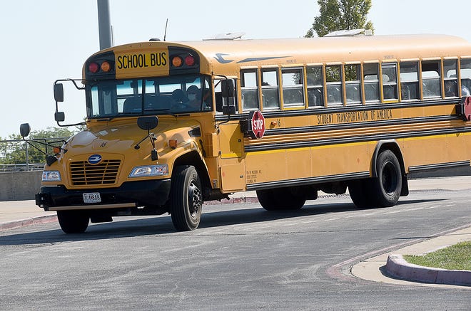 A school bus driver leaves Battle High School in September en route to Hickman High School with students.