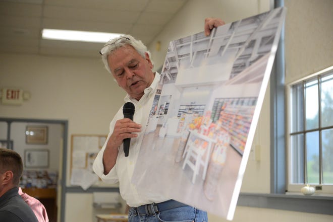 John Gordon, vice president of construction for Englefield Oil, presents a rendering of the convenience store.
