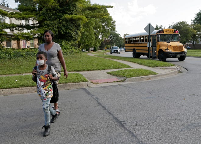 Shaunita Farmer, 38, of the Northeast Side, says it can be stressful waiting for her son Raheem Farmer, a third grader at Ecole Kenwood French Immersion Elementary School, to get to his bus stop in the evening because the bus is usually late due to a driver shortage that is  plaguing schools nationwide.  “If we couldn’t get the busing issue together, maybe the kids should have stayed remote," she said.