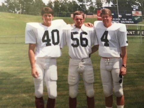 Stan Stipe (center) was a 170-pound long snapper with the Georgia Southern football team in the 1980s. Here he is with teammates Rob Whitton (left) and Pat Parker. He died in 2020, a few years after being diagnosed with early-onset Alzheimer's disease. The local Alzheimer's Association will be auctioning off a football autographed by New England Patriot Mac Jones, whom Stipe coached in baseball in Mandarin, and Jaguars quarterback Trevor Lawrence.
