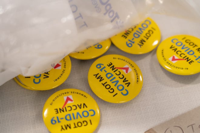 Buttons are spread out to give to people after getting the Covid-19 vaccinations during a community vaccination event at Northport Public School in Northport on Thursday, September 16, 2021.